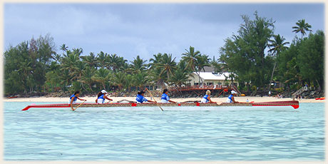 female team in a typical polynesian outrigger canoe for 6 paddlers